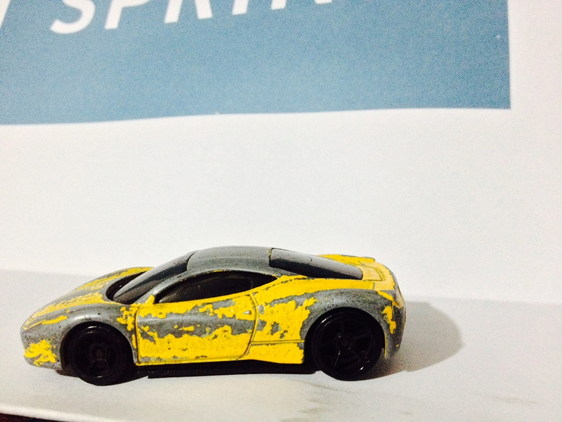 Illustration for article titled Presenting: the most beat-up (but still butt-kicking) 1:64 Ferrari 458 ever